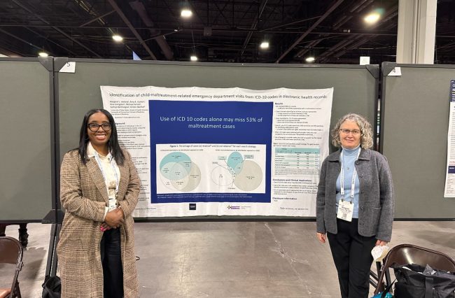 Amy Hunter and Margaret Holland in front poster