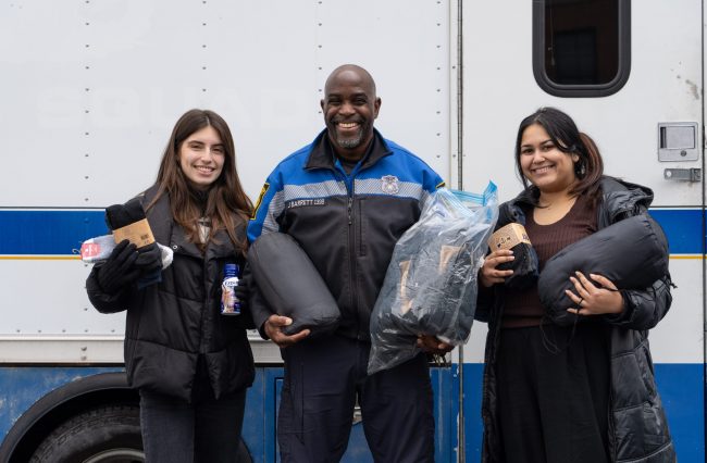 Students Naime Gilani and Narayani Ballambat with Hartford Police Officer Jim Barrett