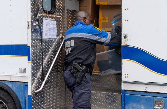 Officer Barrett putting the donations in the police van